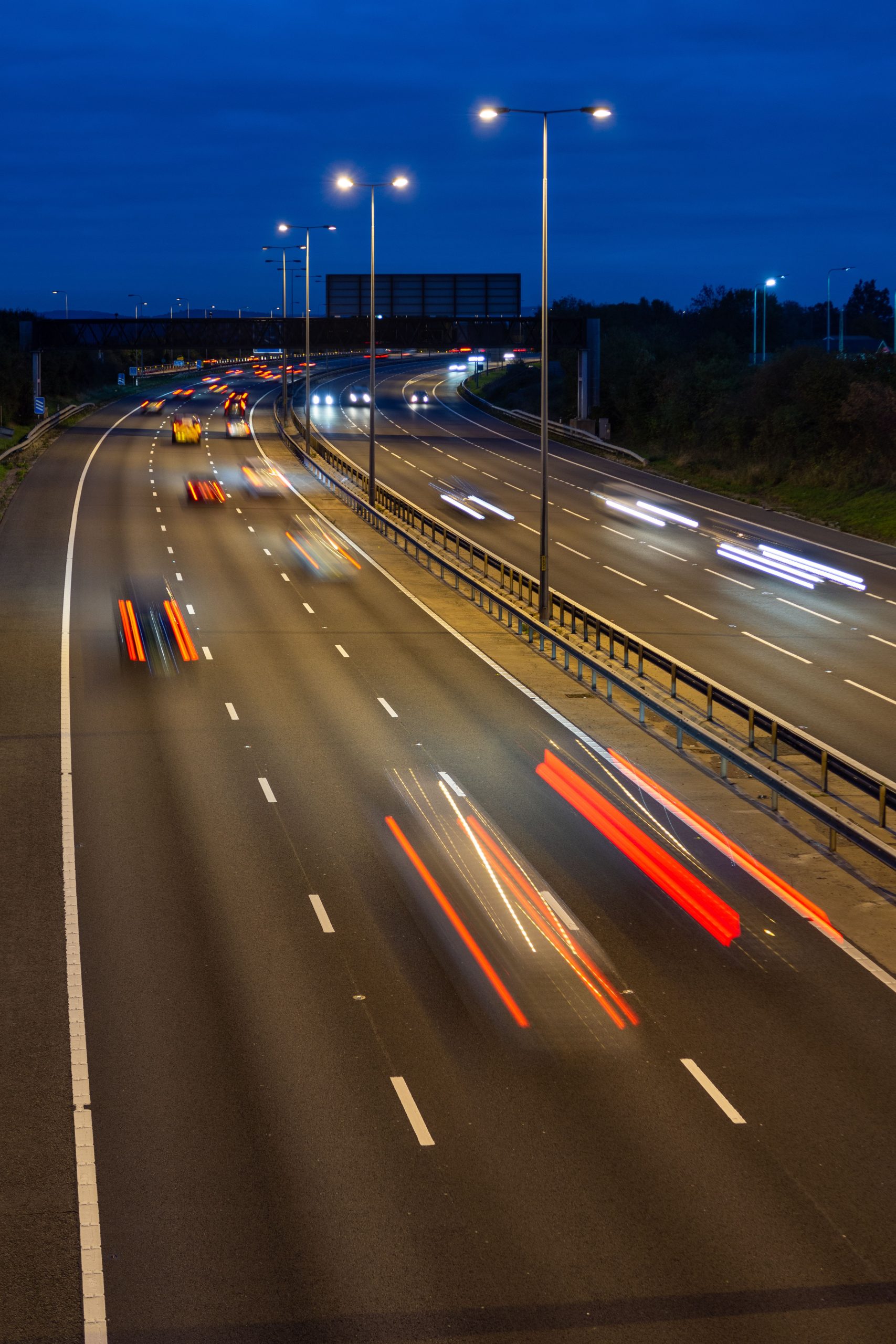 Speeding traffic driving along the M5 motorway at night.